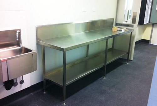 Stainless bench with twin sinks and a pre-rinse tap