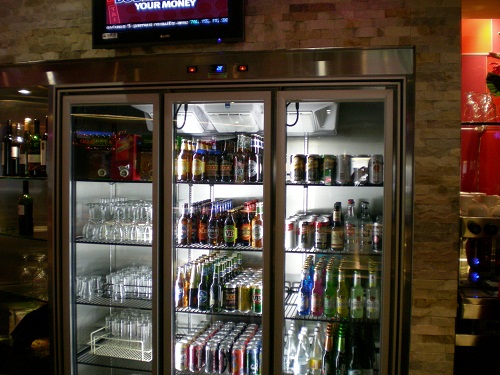 Lit glass-door drinks cabinet in a shop